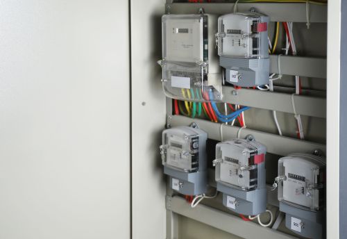 Electric meters and wires in fuse box, space for text. Energy measuring device