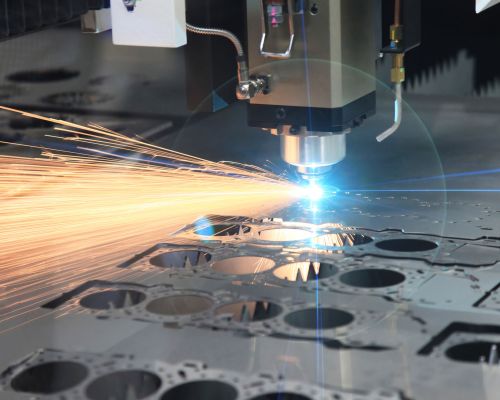 The CNC laser cut machine while cutting the sheet metal with the sparking light
