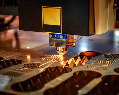 CNC Laser cutting of metal, modern industrial technology. . Small depth of field. Warning - authentic shooting in challenging conditions. A little bit grain and maybe blurred.
