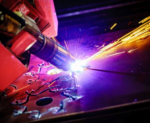 CNC Laser plasma cutting of metal, modern industrial technology. Small depth of field. Warning - authentic shooting in challenging conditions. A little bit grain and maybe blurred.